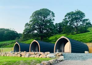 a building with three domes and a pile of rocks at The Huts at Highside Farm in Keswick
