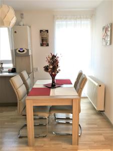 a dining room table with a vase of flowers on it at Luxury Mountain View Apartment in Braşov