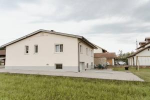 a white house with a black roof at Ferienhaus Barbara in Hard