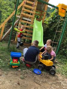 a group of children playing with toys in a playground at Andrei in Sasca Montană