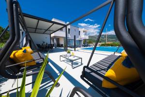 a view of the pool from the deck of a villa at Villa Sky - Heating Pool in Kastel Novi