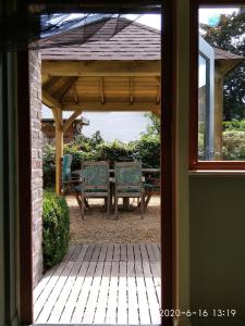 a patio with a table and chairs under a pavilion at Holiday home Harmony in Brecht
