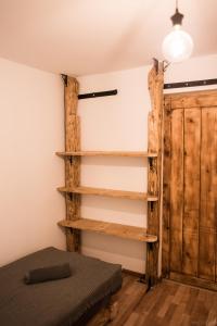 a room with wooden shelves and a bed at Apartamenty u Janka in Krynica Zdrój