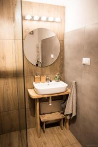 a bathroom with a sink and a mirror at Apartamenty u Janka in Krynica Zdrój