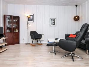 a living room with two chairs and a couch at 4 person holiday home in R m in Rømø Kirkeby