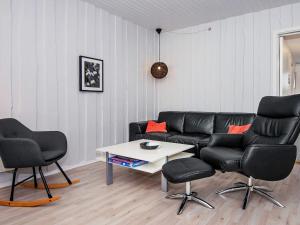 a living room with a couch and two chairs and a table at 4 person holiday home in R m in Rømø Kirkeby