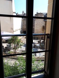 a view from a window looking out onto a courtyard at galerie Angle3 in Quimper