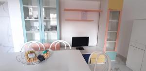een keuken met een witte tafel en 2 stoelen bij Il fortino in Otranto