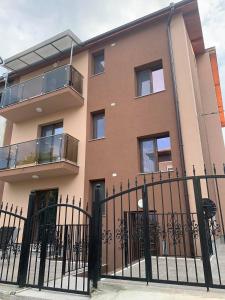 a building with a fence in front of it at Vivian Apartaments in Sandanski