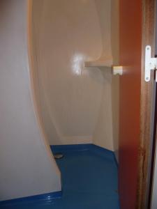 a white toilet in a room with a blue wall at Class'eco Charleroi in Charleroi