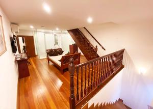 a living room with a staircase and a couch at Heeren Straits Hotel in Malacca