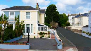 a white house on the side of a street at Marmalade Bed & Breakfast in Torquay