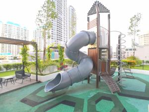 a slide in a playground in a city at The Landmark by Comfy in George Town