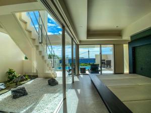 a living room with a staircase in a house at KEN KEN VILLA YUUMODORO in Motobu