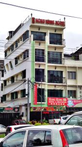 a building with cars parked in front of it at Hong Kong Hotel in Brinchang