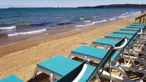a row of beach chairs sitting on the beach at Brio Beach Inn in Traverse City