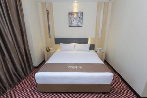 Postel nebo postele na pokoji v ubytování Metro Hotel Bukit Bintang
