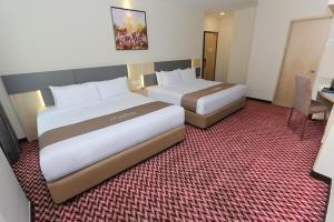 Postel nebo postele na pokoji v ubytování Metro Hotel Bukit Bintang