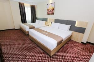 Postel nebo postele na pokoji v ubytování Metro Hotel Bukit Bintang