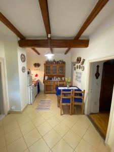 a kitchen and dining room with a table at Kolokán vendégház in Sarud