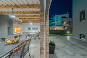 a patio with a table and chairs and a building at VILLA SOFIJA in Zaton