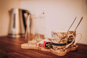 a coffee cup sitting on top of a wooden table at Villa Amfora in Ohrid