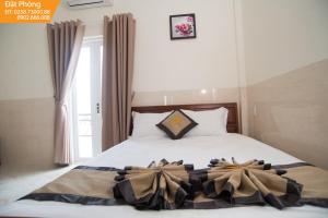 Postel nebo postele na pokoji v ubytování Magnolia Hotel Cam Ranh