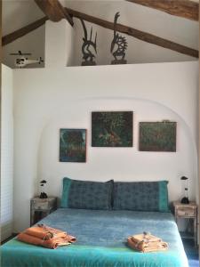 a bedroom with a blue bed with two bags on it at Villa Fonte Tartaruga Trevignano Romano in Trevignano Romano