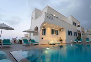 a villa with a swimming pool in front of a building at Anna's in Karterados