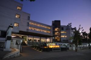 a large building with lights in front of it at Hotel Lake View in Saputara