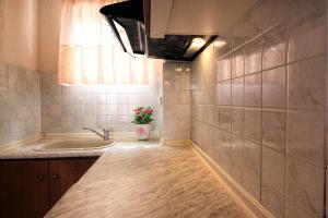a small bathroom with a sink and a tub at GOLDEN SUN STUDIOS in Kallithea Halkidikis +23 photos