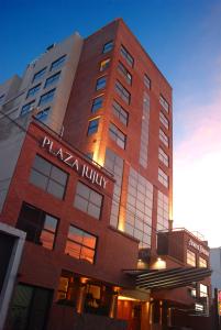 a tall red building with a sign on it at Howard Johnson Plaza Jujuy in San Salvador de Jujuy