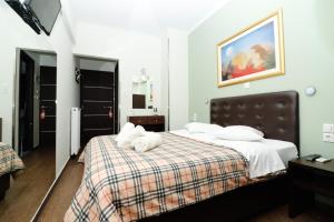 Athens Choice Hotel tesisinde bir odada yatak veya yataklar