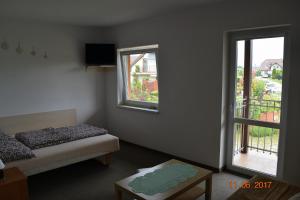 a room with two beds and a window at Aga Pokoje Gościnne - Tylko dla dorosłych in Rewal