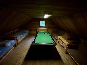a room with a pool table in a cabin at Morávka chalupa in Morávka