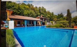 a swimming pool in front of a house at Peace of mind N 3 in Poljane