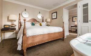 a bedroom with a bed and a dresser at King Street Townhouse in Manchester