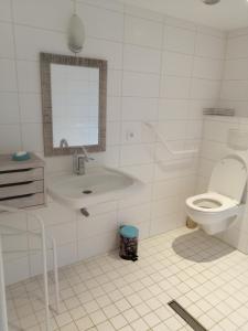 a white bathroom with a toilet and a sink at Gîte Pierre et Marie in Mellecey +20 photos
