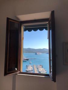 a window in a room with a view of a harbor at Le Stanze sul Mare in Portoferraio