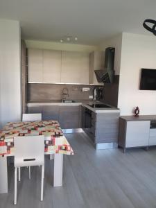 a kitchen with a table and a sink and a stove at Pisogne new apartment in Pisogne
