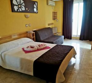 Postel nebo postele na pokoji v ubytování Hotel Alaska