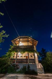 a building with a balcony and stairs at night at Villa Anna in Bled