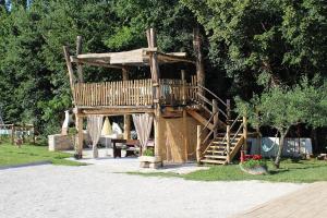 a large wooden tree house with a wooden staircase at Apartment Modrusani 1561 in Žminj