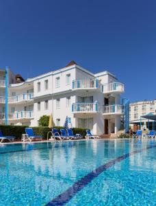 a large swimming pool in front of a building at Sunset Village in Didim