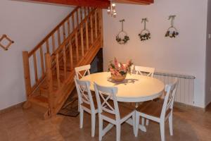 a dining room with a table and chairs and a staircase at Apartamento El Molino in Tramacastilla de Tena