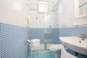 a blue and white bathroom with a shower and a toilet at Hotel La Meridiana in Sorrento