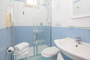 a bathroom with a shower and a toilet and a sink at Hotel La Meridiana in Sorrento