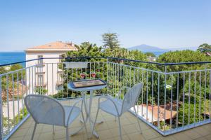 a balcony with two chairs and a table on it at Hotel La Meridiana in Sorrento