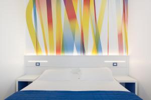 a bedroom with a bed and a colorful curtain at Hotel La Meridiana in Sorrento