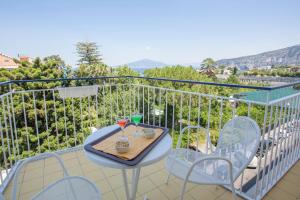 a balcony with a table and two glasses of wine at Hotel La Meridiana in Sorrento